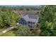 Beautiful home showcasing a balcony and surrounded by mature trees offering privacy at 4385 Ten Shillings Way, Hollywood, SC 29470