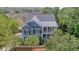 Charming two-story home boasts a lovely balcony and mature trees enhancing its curb appeal at 4385 Ten Shillings Way, Hollywood, SC 29470