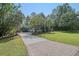 Inviting home featuring a brick driveway and a well-manicured lawn at 4385 Ten Shillings Way, Hollywood, SC 29470