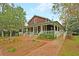 Community building with a covered porch, brick walkway, and landscaped garden at 4385 Ten Shillings Way, Hollywood, SC 29470