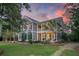 Stately two-story home with double porches, lush landscaping, and inviting curb appeal at 4385 Ten Shillings Way, Hollywood, SC 29470