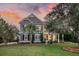 Charming two-story home with landscaped front yard, mature trees, and inviting entrance at 4385 Ten Shillings Way, Hollywood, SC 29470