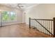 Bright hallway with wood floors and a staircase at 4385 Ten Shillings Way, Hollywood, SC 29470