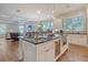Spacious kitchen with an island featuring bar seating and a wine fridge, adjacent to a cozy living area at 4385 Ten Shillings Way, Hollywood, SC 29470