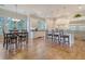 Open-concept kitchen featuring a large island with seating, stainless appliances, and seamless flow to the dining area at 4385 Ten Shillings Way, Hollywood, SC 29470
