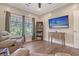 Comfortable living room showcasing a large window, hardwood floors, and neutral paint colors at 4385 Ten Shillings Way, Hollywood, SC 29470