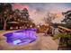 Outdoor area with pool, fire bowls, hot tub, umbrella, lounge chairs, string lights, and travertine deck at 4385 Ten Shillings Way, Hollywood, SC 29470