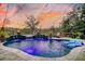 Inviting backyard pool and hot tub area with string lights, fire bowls, and cozy seating at 4385 Ten Shillings Way, Hollywood, SC 29470