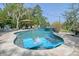 Sparkling pool with a sun umbrella, relaxing lounge chairs, and a tranquil waterfall feature, creating a perfect outdoor oasis at 4385 Ten Shillings Way, Hollywood, SC 29470