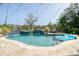 Beautiful custom pool with integrated waterfall and lush landscaping, perfect for relaxing outdoors at 4385 Ten Shillings Way, Hollywood, SC 29470