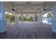 Expansive porch with a beautiful wood floor and serene view of the landscaped yard at 4385 Ten Shillings Way, Hollywood, SC 29470