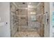 Stunning shower with dual shower heads, travertine tile, niche, and glass surround at 4385 Ten Shillings Way, Hollywood, SC 29470
