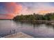 Scenic riverfront view with dock, calm water, and sunset colored sky at 4385 Ten Shillings Way, Hollywood, SC 29470