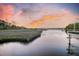 Scenic waterfront view featuring a tranquil river and a vibrant sunset creating a serene and picturesque setting at 4385 Ten Shillings Way, Hollywood, SC 29470