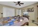 Bedroom features a bed with patterned quilt, a ceiling fan, and lots of natural light at 522 W Butternut Rd, Summerville, SC 29483