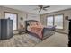 Primary bedroom with a large bed, ceiling fan, and natural light from the windows at 522 W Butternut Rd, Summerville, SC 29483