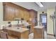 Bright kitchen with wood cabinetry, neutral countertops, island, and stainless steel appliances at 522 W Butternut Rd, Summerville, SC 29483