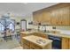 Well-lit kitchen with wood cabinets, breakfast bar, and dining area at 522 W Butternut Rd, Summerville, SC 29483