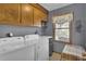 Functional laundry room with upper cabinets, washer, and dryer at 522 W Butternut Rd, Summerville, SC 29483