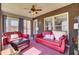 Cozy sun room with red leather furniture, brick walls, and bright natural light at 522 W Butternut Rd, Summerville, SC 29483