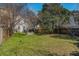 A well-maintained backyard with lush lawn and a charming seating area under mature trees at 53 America St, Charleston, SC 29403