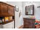 Well-lit bathroom with a dark vanity, storage cabinet, and decorative accents at 53 America St, Charleston, SC 29403