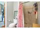 Cozy bathroom featuring a tiled walk-in shower with a floral shower curtain and charming decorative accents at 53 America St, Charleston, SC 29403