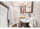 A cozy bathroom with a dark wood vanity, storage, and a large mirror at 53 America St, Charleston, SC 29403