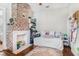 Bedroom showcasing decorative brick fireplace and hardwood floors at 53 America St, Charleston, SC 29403