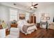 Calm bedroom featuring a large window, hardwood floors, and a cozy white armchair at 53 America St, Charleston, SC 29403