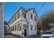 Two-story home featuring double porches with white railings and classic details at 53 America St, Charleston, SC 29403