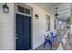 Charming front porch with blue chairs, a hammock, and a welcoming entrance at 53 America St, Charleston, SC 29403