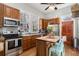 Well-equipped kitchen with stainless steel appliances, wood cabinets, and a functional island at 53 America St, Charleston, SC 29403