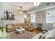 Spacious living room features neutral-toned sofas, ceiling fans and a large area rug at 53 America St, Charleston, SC 29403