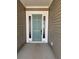 Inviting front door with sidelights and white trim, creating a welcoming entrance at 586 Marsh Cove Cir, Summerville, SC 29486