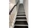 Stylish staircase featuring contrasting dark treads and white risers, leading to the upper level at 586 Marsh Cove Cir, Summerville, SC 29486
