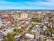 An aerial shot showcases a cityscape with a bridge, tall buildings, and historic homes with lush foliage at 6 Halsey St, Charleston, SC 29401