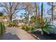 Spacious backyard with a stone path, palm trees, and a spiral staircase offering private outdoor living at 6 Halsey St, Charleston, SC 29401