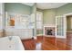 Bright bathroom featuring double vanity, tub, and charming fireplace, creating a cozy and luxurious space at 6 Halsey St, Charleston, SC 29401