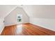 Attic bedroom with hardwood floors, natural light from a window and a clean, minimalist style at 6 Halsey St, Charleston, SC 29401