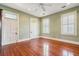 Sunlit bedroom featuring hardwood floors, ceiling fan, and classic trim at 6 Halsey St, Charleston, SC 29401