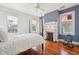 Charming bedroom featuring a classic fireplace, complemented by ample natural light streaming through multiple windows at 6 Halsey St, Charleston, SC 29401