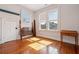 Empty bedroom featuring hardwood floors, ample natural light, and neutral wallpaper at 6 Halsey St, Charleston, SC 29401