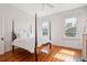 Bright bedroom featuring a four-poster bed, complemented by natural light through multiple windows at 6 Halsey St, Charleston, SC 29401
