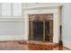 Charming brick fireplace with an ornate screen and vintage hearth tools at 6 Halsey St, Charleston, SC 29401