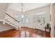 Elegant foyer featuring hardwood floors, a staircase, and a decorative chandelier at 6 Halsey St, Charleston, SC 29401