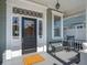 Inviting front porch with classic details, featuring a black front door and bench seating at 6 Halsey St, Charleston, SC 29401