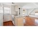 Kitchen with an island and bar stool next to a living room and a utility closet at 6 Halsey St, Charleston, SC 29401