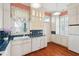 Bright kitchen featuring white cabinets, blue tiled countertops, and vintage accents at 6 Halsey St, Charleston, SC 29401