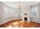 Bright living room featuring hardwood floors, a fireplace, and ample natural light from windows at 6 Halsey St, Charleston, SC 29401